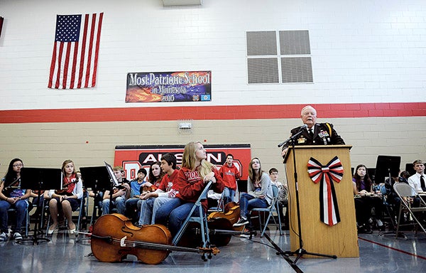 Keynote speaker Norm Hecimovich talks about the virtues of remembering veterans during the Veterans Day program at Ellis Middle School Monday morning. Eric Johnson/photodesk@austindailyherald.com