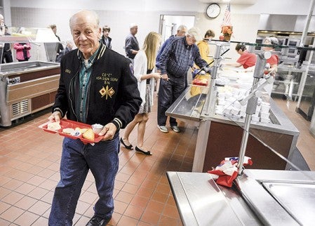 Veteran John Cafourek gets his breakfast prior to a Veterans Day program held at Ellis Middle School Monday morning. Eric Johnson/photodesk@austindailyherald.com