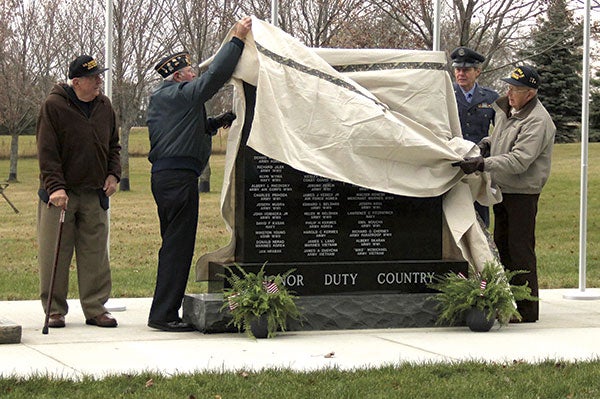 Veterans unveil a new memorial at Bohemian National Cemetery near Myrtle during a dedication ceremony on Saturday.  Kelli Lageson/newsroom@austindailyherald.com