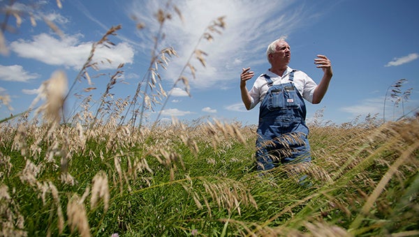 Leroy Perkins stands on July 26 in his field of grass, which is part of the Conservation Reserve Program near Corydon, Iowa. Perkins must make a decision to either leave the highly erodible field in grass or break ground to plant corn, which is at high prices in part because of the ethanol mandate. -- Charlie Riedel/Associated Press