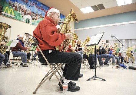 Larry Nerison plays his tuba during the third annual TubaChristmas concert  las year at the Oak Park Mall. Herald file photo