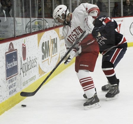 Austin's Kenny Ree fights off Albert Lea's Brady Loch for a loose puck in Riverside Arena Tuesday. -- Rocky Hulne/sports@austindailyherald.com