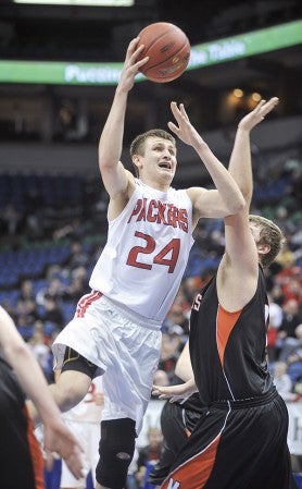 Austin’s Tom Aase shoots from the lane over Aaron Mathiowetz in the second half last March in the Class AAA semifinals of the Minnesota State Boys Basketball Tournament at the Target Center. Herald file photo