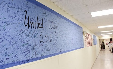 A United Way poster with names of all QPP’s donors highlights the hallway near QPP’s main offices. 