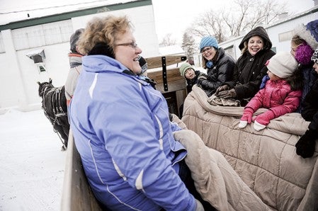 Riders enjoy a scenic, if not chilly ride, through the Mower County Fairgrounds Satuday by horse-drawn wagon during Christmas in the County at the Mower County Fairgrounds. Eric Johnson/photodesk@austindailyherald.com