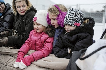 The Cline sisters, Julia 4, from left, Grace 9 and Adi 6 snuggle together for warmth during a horse-drawn wagon ride during Christmas in the County Saturday at the Mower County Historical Society. The sisters were with their grandparents Fred and Sue Cline who are off-camera to the right. Eric Johnson/photodesk@austindailyherald.com