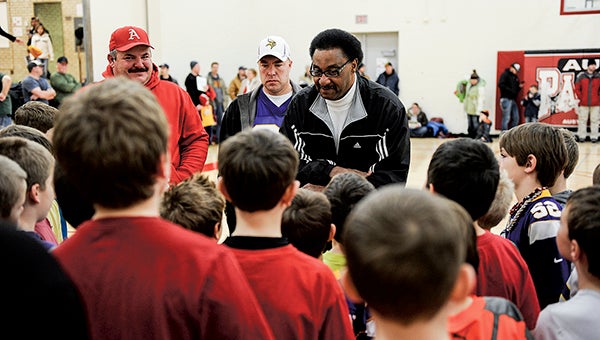 Former Minnesota Viking Chuck Foreman talks to kids before sending them off for drills during a camp by himself and another former Viking, Carl Lee Saturday morning at Ellis Middle School. Eric Johnson/photodesk@austindailyherald.com
