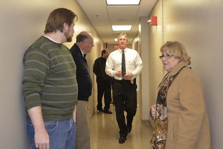 Austin City Council members wait for Police Chief Brian Krueger to continue a tour of the remodeled Mower County Law Enforcement Center and Government Center Tuesday. Much of the walls in the LEC basement were redone to prevent water damage. 