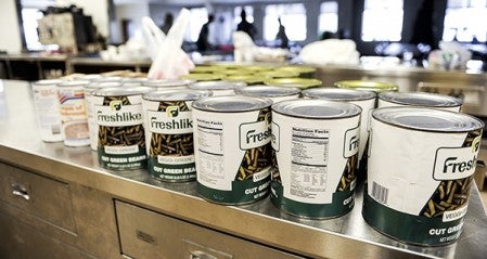 Cans of food are lined up in the kitchen of St. Olaf Lutheran Church during preparation for the dinner. 