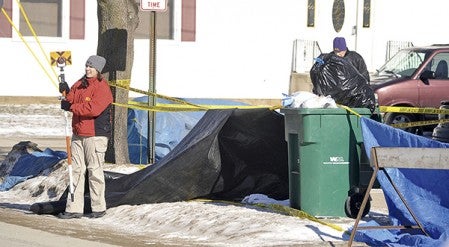 Members of the Minnesota Bureau of Criminal Apprehension work the scene in front of a home that was the site of a suspected homicide in the 500 block of Fourth Street NW just south of Austin and Pacelli Schools in February. -- Herald file photo