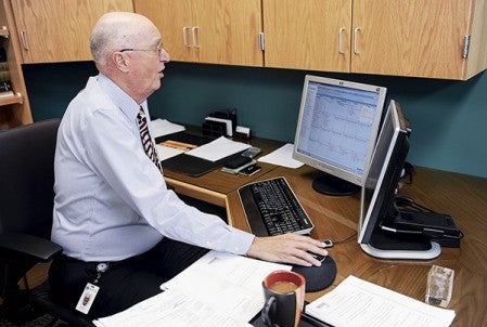 Judge Rysavy works from his computer in his chambers, where he can access files electronically, as more and more files are being converted to electronic files. 