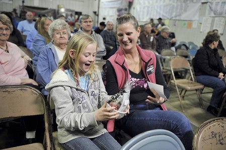 Maggie Davis, 10, was all smiles when her mother Joed won cat food, a bowl and cat toy.