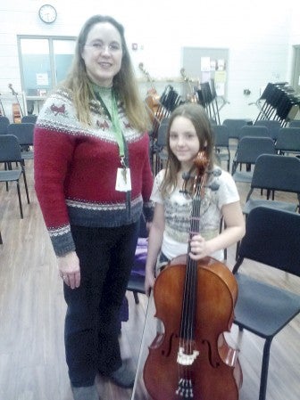 I.J. Holton orchestra teacher Brenda Radloff, left, with fifth-grader Kaylee Johnson, the first student to play the new cello.  Photo provided