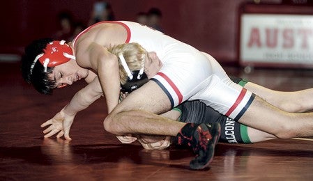 Austin's Christopher Romero tries to pin Faribault's Kyle O'Neil in the second period at 106 pounds Thursday night in Ove Berven Gym. Eric Johnson/photodesk@austindailyherald.com