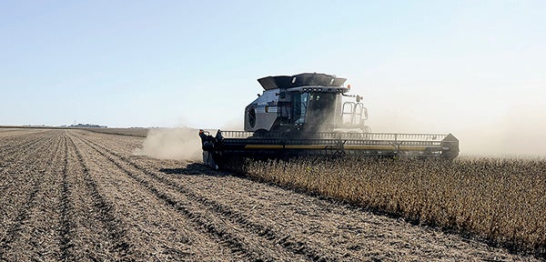 Roger Toquam harvests a field of soybreans in a field near the family farm northeast of Blooming Prairie last year. The USDA just upped this year's corn and soybean harvest to record levels. Herald file photo