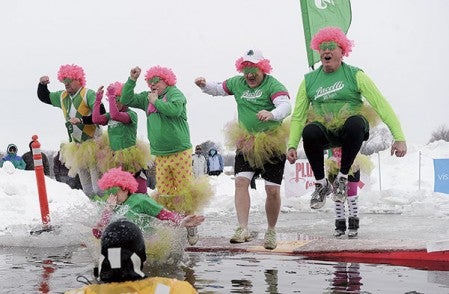 Members of team Pacelli make the jump into East Side Lake Saturday during the Plunging for Pink for Paint the Town Pink.