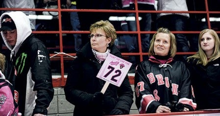 Brenda Potach makes a bid Saturday night on the jersey of Bruins’ player Sam Kauppila during the Paint the Rink Pink jersey auction at Riverside Arena. 