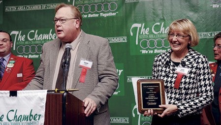 Austin Public School’s Superintendent David Krenz, left, and I.J. Holton intermediate School Principal Jean McDermott accept the award for Project of the Year during the Austin Area Chamber of Commerce Winter Banquet and Awards Program Tuesday night. Eric Johnson/photodesk@austindailyherald.com