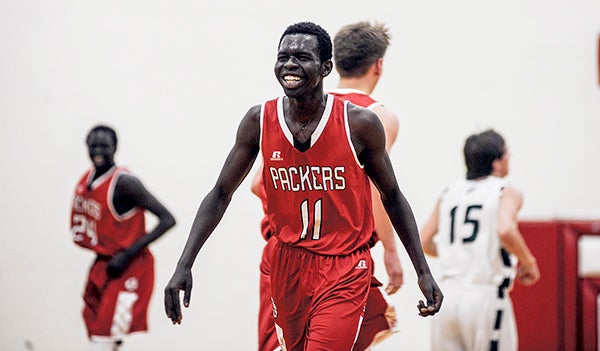 Austin's Ajuda Nywesh was all smiles Thursday night as the Packers went on to beat Faribault 73-42 in the first round of the Section 1AAA tournament in Packer Gym. Eric Johnson/photodesk@austindailyherald.com