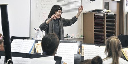 Composer Shelley Hansen leads the Austin High School Wind Ensemble in a quick run of her piece, "Albanian Dance," at AHS on Jan. 9. The AHS music program will showcase its skills at the annual Minnesota Music Educators Association in February. Trey Mewes/trey.mewes@austindailyherald.com