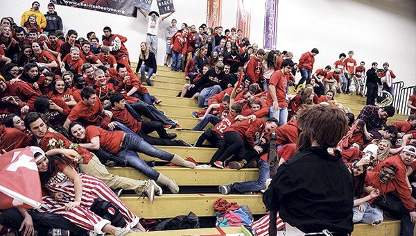 Calling itself the “Red Sea,” the Austin student body fan base parts for Moses (Austin student Mark Mizrachi) to reveal Ryan Synoground holding the tablets proclaiming Austin’s return to state before the Packers’ semifinal game win over New Prague Saturday night in Packer Gym. Top-seeded Austin will take on No. 2-seeded Red Wing in the Section 1AAA title game at Mayo Civic Center Friday at 8 p.m. The Packers are aiming for their third straight trip to the state tournament. 