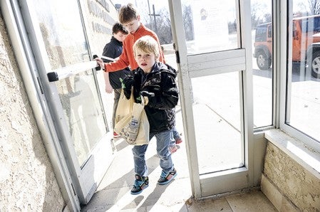 Dylan Bellrichard, a member of Cub Scout 113, rolls into the Salvation Army Saturday morning after gathering food for the annual Scouting for Food food drive. Eric Johnson/photodesk@austindailyherald.com