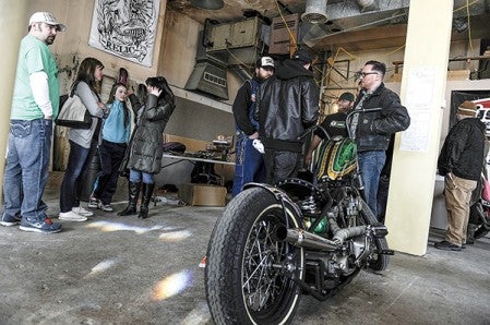 Visitors to the Build Art Bike Show Saturday gather and talk at the downtown bank building.