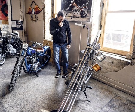 Jay Sullivan of Geneva looks over a motorcycle on display at the Build Bike Art Show.