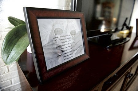 A picture of Mark and Mikayla Austin’s twins sits on the TV stand in their home. Born in 2009, the twins passed because they were born premature.  Eric Johnson/photodesk@austindailyherald.com
