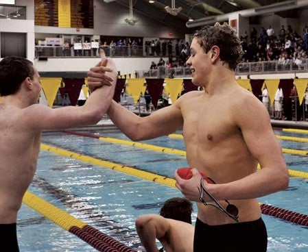 Seth Clasen, left, and Sawyer Myers, right, celebrate after the Austin 200-freestyle relay team broke a school record and took third at the Class 'A' state swimming and diving meet in Minneapolis Saturday. -- Rocky Hulne/sports@austindailyherald.com