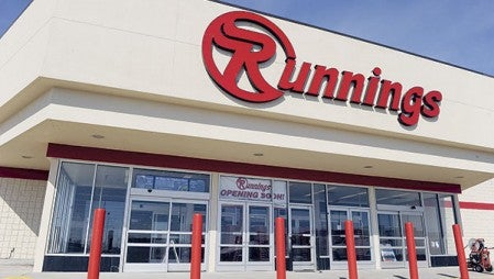 An “opening soon” sign hangs in the door of Runnings recently. The store is set to open within a week. Herald file photo