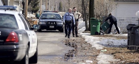 Austin Police and a Mower County deputy search the ally and yards near a home on the 800 block of Ninth Avenue Southwest Monday afternoon. Eric Johnson/photodesk@austindailyherald.com