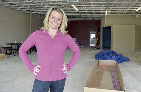 Jenn Jenkins stands in what will soon be her 6,100-square-foot gym and fitness center at 803 18th Ave. NW. Total Fitness is scheduled to open in June. -- Trey Mewes/trey.mewes@austindailyherald.com