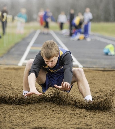 Hayfield's Chad Kruger lands on his first attempt in the long jump Thursday in Hayfield. Eric Johnson/photodesk@austindailyherald.com