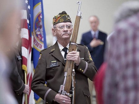A member of Veterans of Foreign Wars Post 447 takes part in retiring the colors at the close of the Albert Lea VA Clinic dedication Friday at Skyline Plaza. Colleen Harrison/Austin Daily Herald