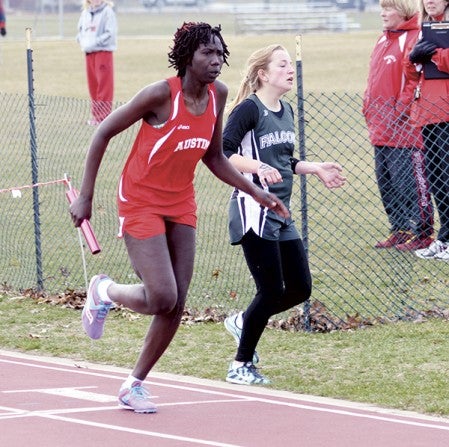 Austin's Ochudo Cham runs in the 4 x 800-meter relay team for the Packers at Larry Gilbertson track and field Thursday. -- Rocky Hulne/sports@austindailyherald.com