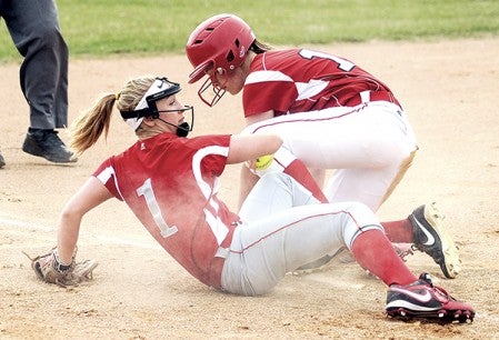 Austin's Abby Bickler looks up after trying to make the tag on Mankato West's Krista Goerger Tuesday evening at Todd Park. Goerger was safe on the play. Eric Johnson/photodesk@austiindailyherald.com