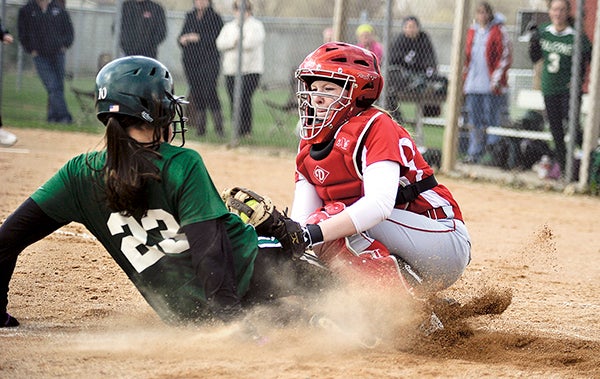 Austin catcher Sydney Murphy puts the tag on Faribault's Bre Breshanhan to get the out at home Friday night at Todd Park. Eric Johnson/photodesk@austindailyherald.com