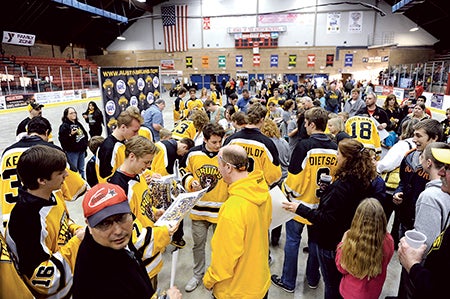 Members of the Austin Bruins mingle with fans and sign autographs after a welcome home Wednesday night at Riverside Arena Wednesday night. 