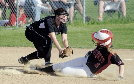 Blooming Prairie's Megan O'Connor reaches to tag Kenyon-Wanamingo's Makayla Sokoloski in the their game of the Subsection 1A tournament Friday at Todd Park. Eric Johnson/photodesk@austindailyherald.com