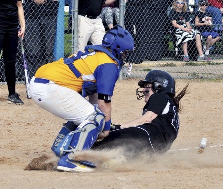 Blooming Priaire's Bria Baldwin is tagged out by Hayfield catcher Grace Mindrup at the plate in the Section 1A West semifinals in Hayfield Wednesday. -- Rocky Hulne/sports@austindailyherald.com