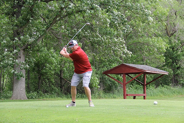 Brian Tollefson tees off during the Dave “Tolly” Tollefson Cancer Research Memorial Golf Outing at Meadow Greens Monday. The even raised $15,000. -- Jason Schoonover/jason.schoonover@austindailyherald.com