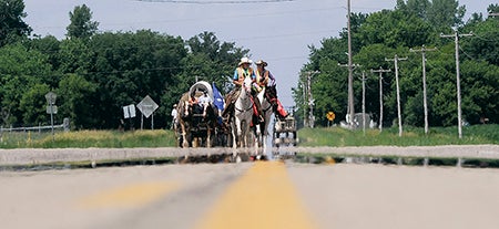 The Friendship Wagon Train nears the corner of County Roads 46 and 34 coming south of Oakland Wednesday afternoon as it makes its way toward Austin.