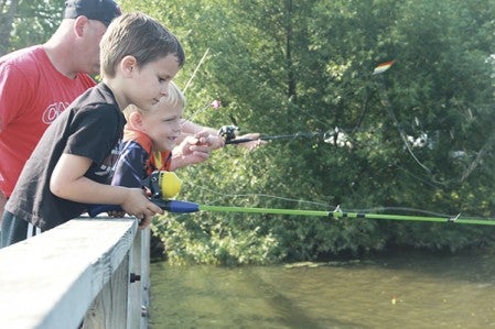 Five-year-old Quinton Frimley, left, and 6-year-old Austin Langille watch their lines in East Side Lake during the Kids Fishing Contest Saturday. Jason Schoonover/jason.schoonover@austindailyherald.com