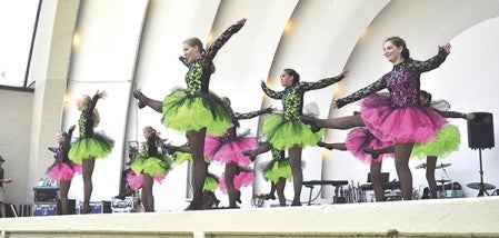The Senior and Junior Taps Company from the Jane Taylor Academy of Dance perform a routine during the Town & Country Day in the Park at Bandshell Park Friday.