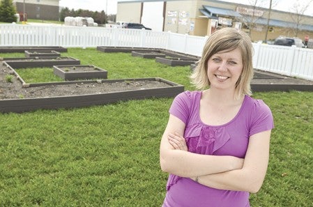 Hy-Vee dietitian Jen Haugen stands out in the Sprouts garden outside of the store in May of 2013. Herald file photo