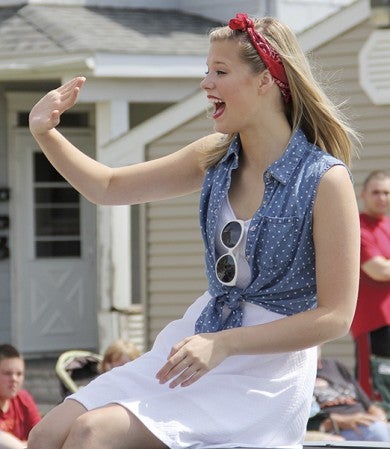 Grand marshal Molly Kate Kestner waves to people along Fourth Avenue Northeast during the parade Friday. 