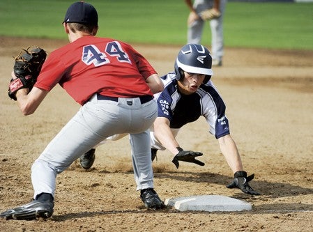 Albert Lea's Jake Kilby dives back into first base on a pick-off attempt before Austin' Alex Ciola can get the tag down during VFW baseball action Wednesday afternoon. Eric Johnson/photodesk@austindailyherald.com