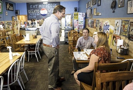 Republican U.S. Senate candidate Mike McFadden talks to James Danielson and Katie Sullivan during a stop at Piggy Blues Friday. Eric Johnson/photodesk@austindailyherald.com