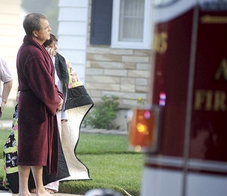 Mayor Tom Stiehm and his wife, Sarah, watch as firefighters battle a blaze at their home Friday morning. 